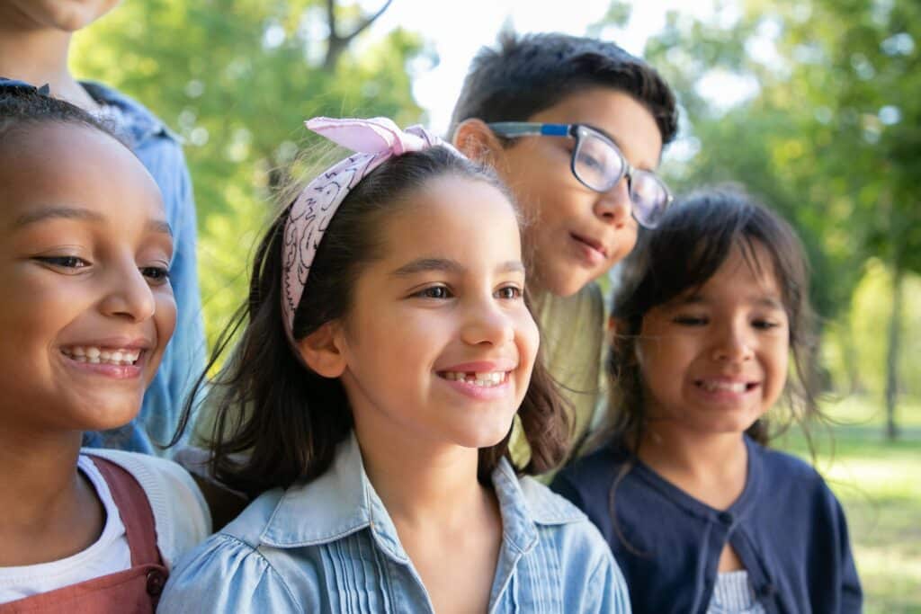 A young, smiling girl with healthy, well-aligned teeth during an orthodontic consultation at Kim Young Orthodontics.